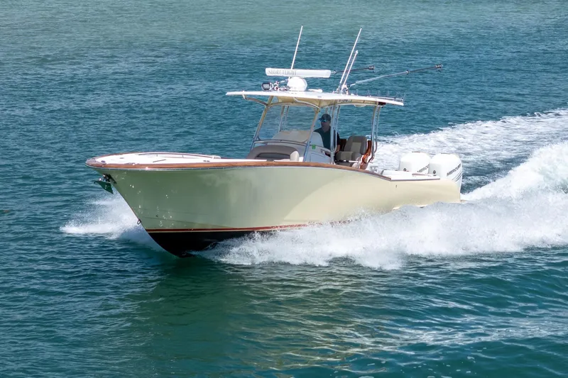 Slide: The Image of 2020 Mag Bay 33 CC boat cruising on open water. - 23