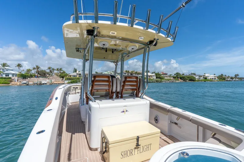Slide: The Image of 2020 Mag Bay 33 CC boat on water, sunny day, coastal homes in background. - 25