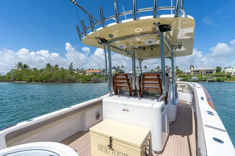Slide: The Image of 2020 Mag Bay 33 CC boat on water, featuring sleek design and comfortable seating. - 26