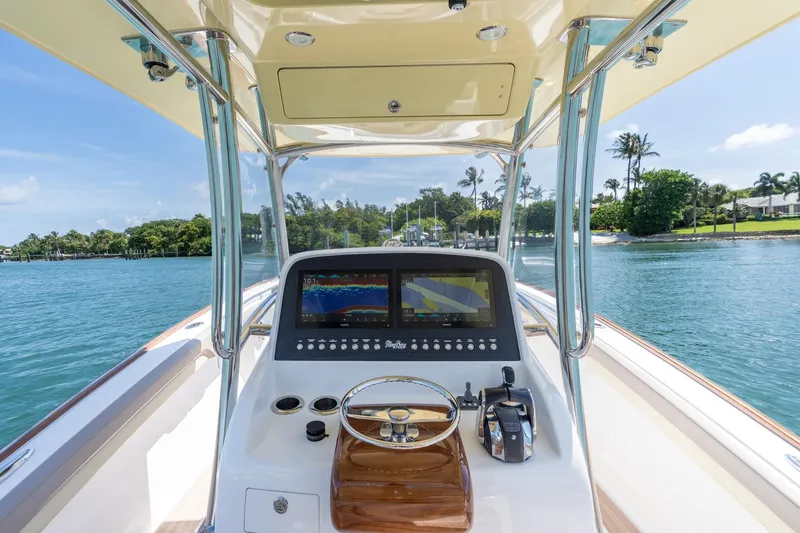 Slide: The Image of 2020 Mag Bay 33 CC boat console with navigation display on a sunny day. - 28