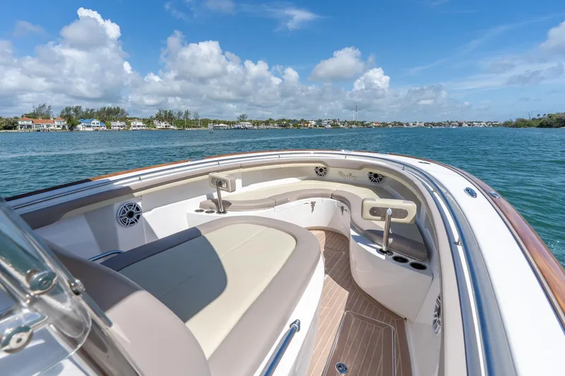 Slide: The Image of 2020 Mag Bay 33 CC boat interior with seating, on a sunny day by the water. - 30