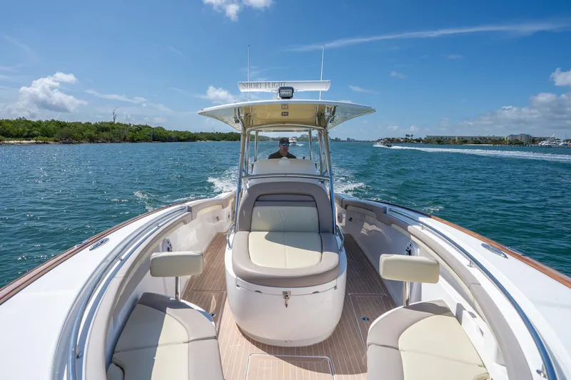 Slide: The Image of 2020 Mag Bay 33 CC cruising on a sunny day, showcasing luxurious seating and sleek design. - 32