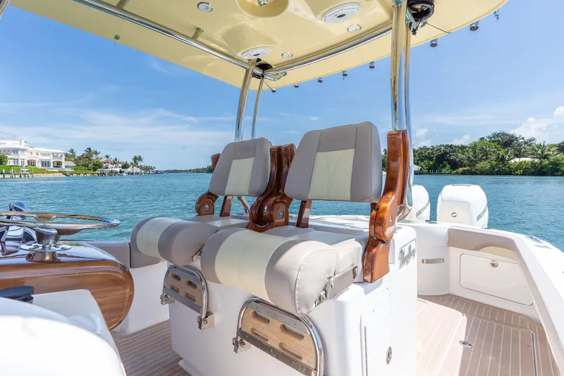 Slide: The Image of 2020 Mag Bay 33 CC boat interior with luxurious seating and scenic waterfront view. - 35