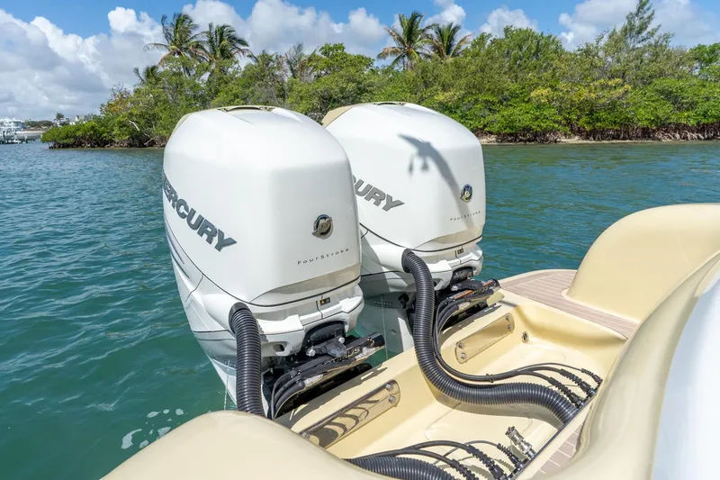 Slide: The Image of 2020 Mag Bay 33 CC boat with twin Mercury outboard engines on a sunny day. - 37