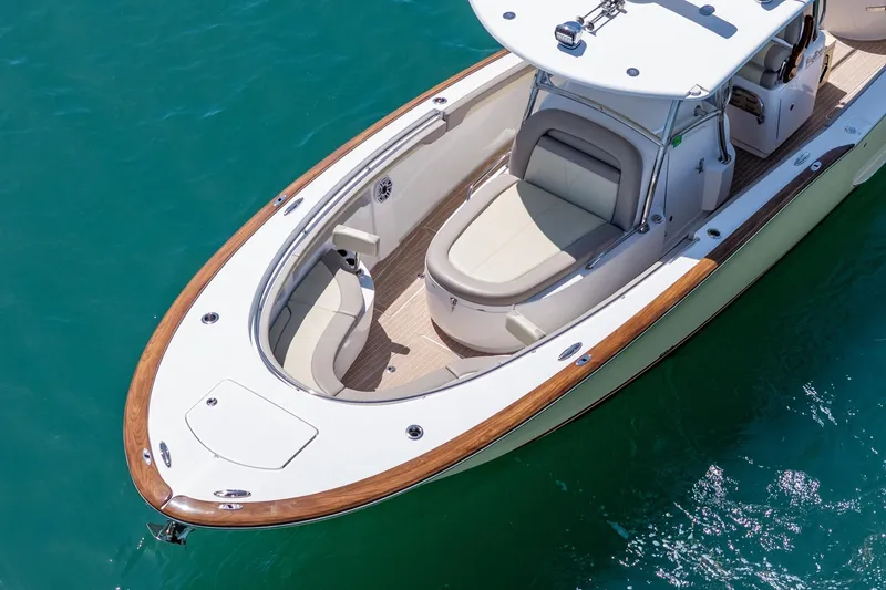 Slide: The Image of 2020 Mag Bay 33 CC boat on clear blue water, featuring sleek design and comfortable seating. - 4
