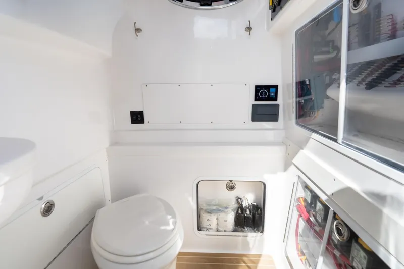 Slide: The Image of Interior of 2020 Mag Bay 33 CC boat featuring a compact, modern bathroom. - 41