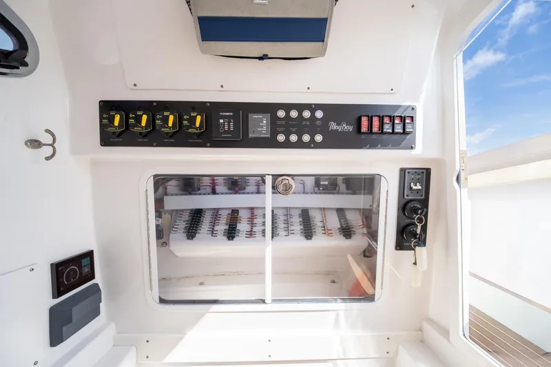 Slide: The Image of Control panel of 2020 Mag Bay 33 CC boat, featuring switches and gauges. - 42