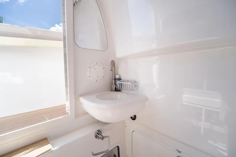 Slide: The Image of 2020 Mag Bay 33 CC boat interior with sink and faucet in bright, modern design. - 43