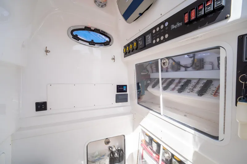 Slide: The Image of Interior view of 2020 Mag Bay 33 CC boat with control panel and storage. - 44