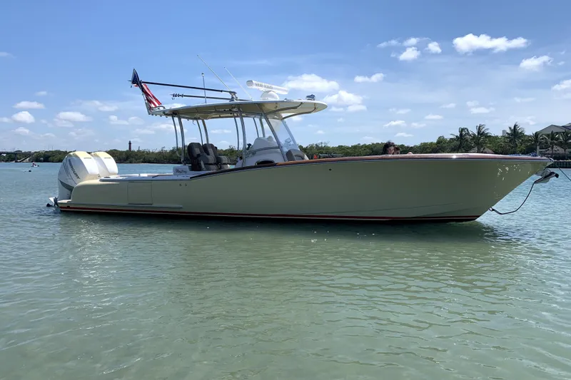 Slide: The Image of 2020 Mag Bay 33 CC boat on calm water, clear sky background. - 5