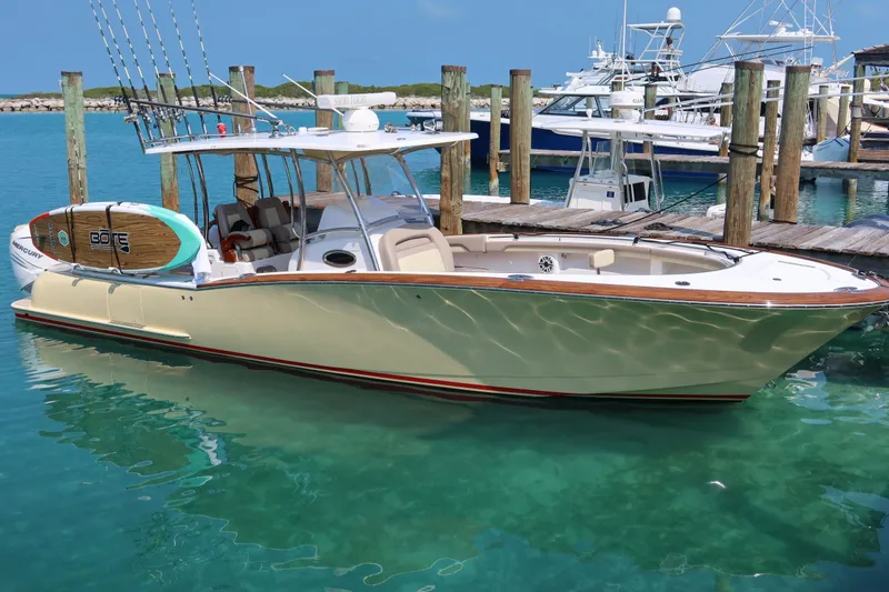 Slide: The Image of 2020 Mag Bay 33 CC boat docked in clear turquoise water. - 8