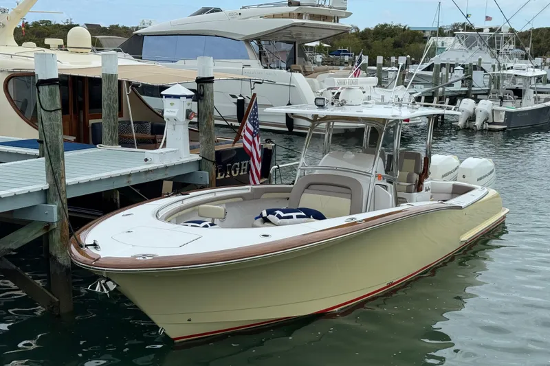 Slide: The Image of 2020 Mag Bay 33 CC boat docked at marina with American flag. - 9