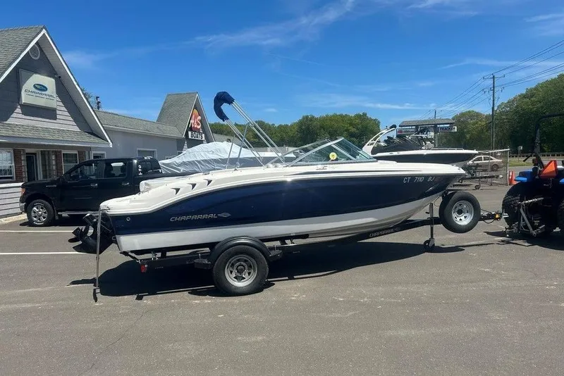 The Image of 2017 Chaparral 19 H2O Sport boat on trailer outside dealership. - 1