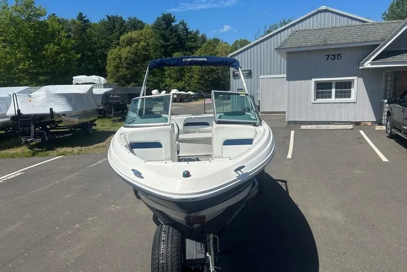 Slide: The Image of 2017 Chaparral 19 H2O Sport boat parked outdoors near a building. - 2