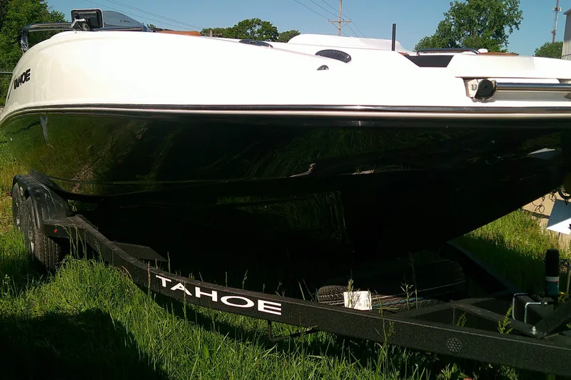 Slide: The Image of 2026 Tahoe 2150 CC boat on trailer in grassy area. - 3
