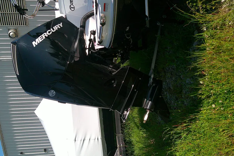 Slide: The Image of Mercury outboard motor on a 2026 Tahoe 2150 CC boat, parked on grass. - 4