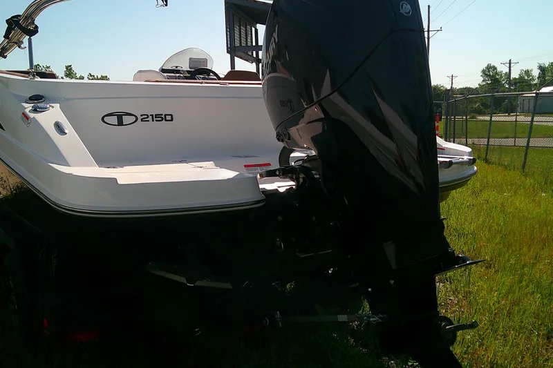 Slide: The Image of 2026 Tahoe 2150 CC boat with powerful outboard motor in grassy area. - 5