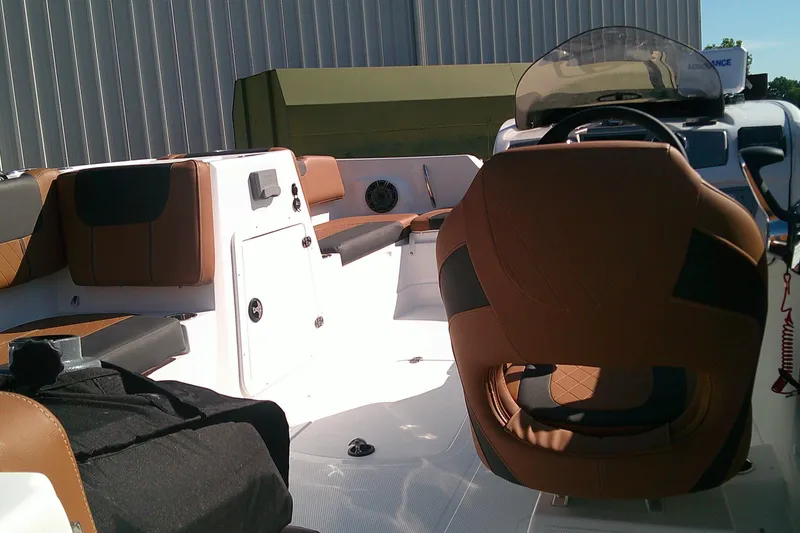 Slide: The Image of 2026 Tahoe 2150 CC boat interior with brown seating and modern dashboard design. - 7