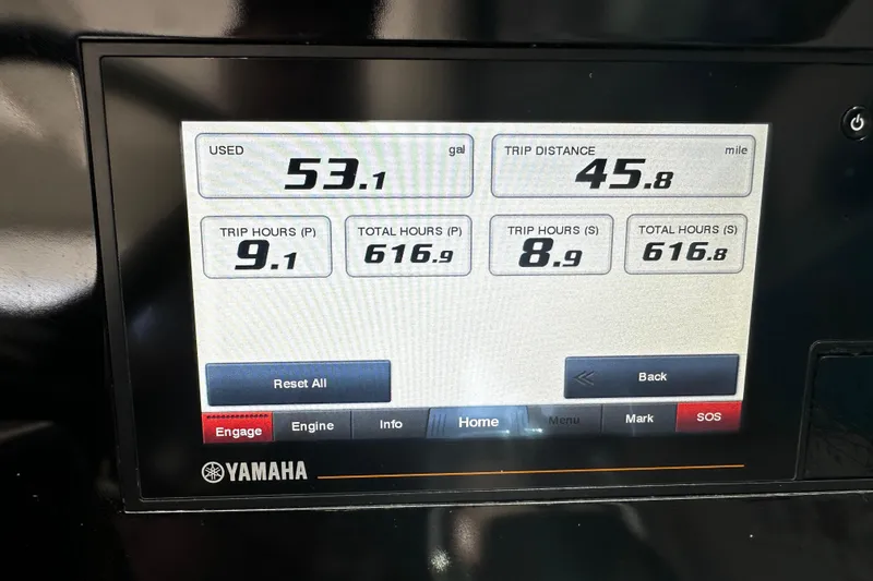 Slide: The Image of Dashboard display of a 2019 Pursuit OS 325 Offshore showing fuel and trip data. - 11