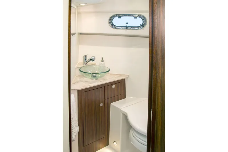 Slide: The Image of Manufacturer Provided Image: 2019 Pursuit OS 325 Offshore bathroom with modern sink and toilet. - 16