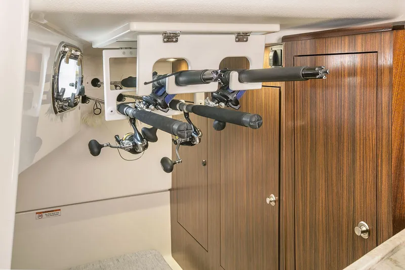 Slide: The Image of Manufacturer Provided Image: 2019 Pursuit OS 325 Offshore cabin with fishing rod storage. - 19