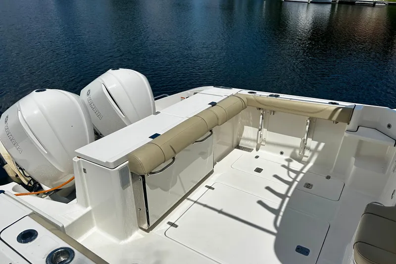 Slide: The Image of 2019 Pursuit OS 325 Offshore boat with Yamaha engines, featuring spacious deck and seating. - 21