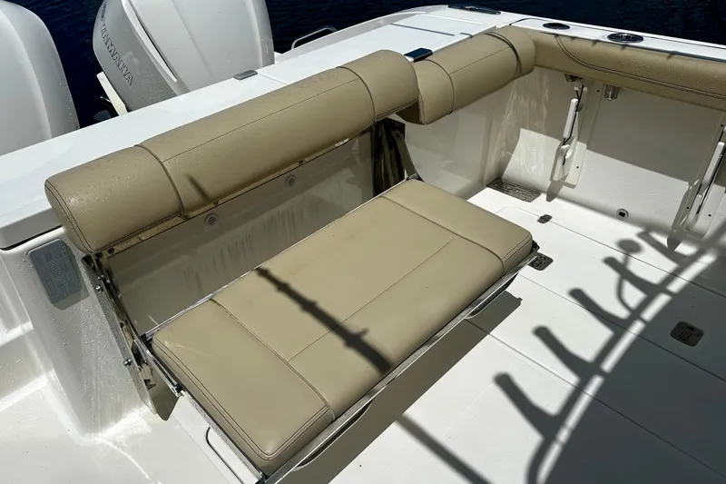 Slide: The Image of 2019 Pursuit OS 325 Offshore boat with beige foldable seating and dual Yamaha engines. - 22