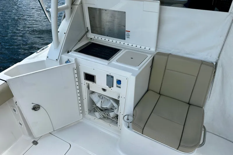 Slide: The Image of 2019 Pursuit OS 325 Offshore boat interior with seating and storage area. - 24