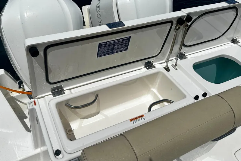 Slide: The Image of Open storage compartments on a 2019 Pursuit OS 325 Offshore boat. - 25