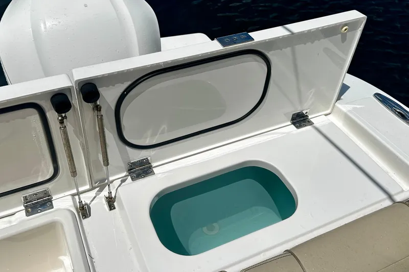 Slide: The Image of Open storage compartment on 2019 Pursuit OS 325 Offshore boat. - 26
