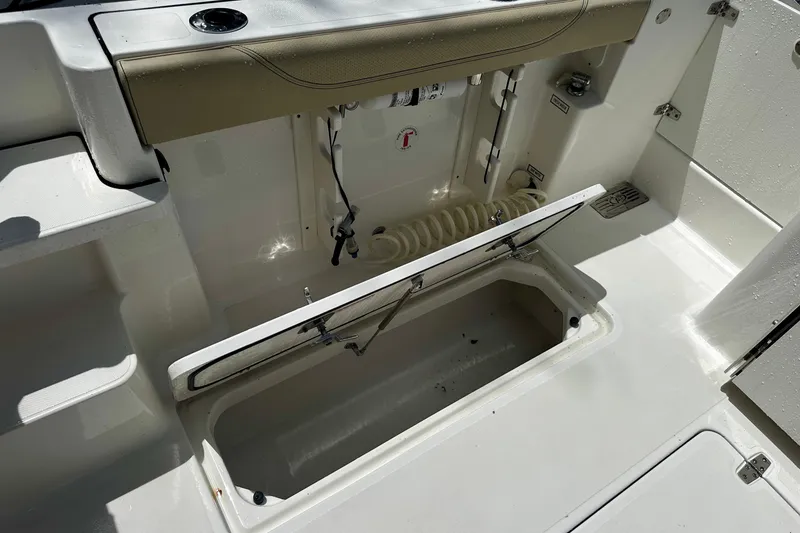 Slide: The Image of 2019 Pursuit OS 325 Offshore boat interior with open storage compartment. - 28