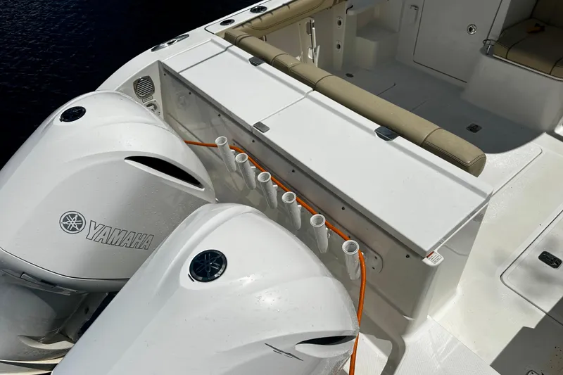 Slide: The Image of 2019 Pursuit OS 325 Offshore boat with Yamaha engines and rod holders. - 30