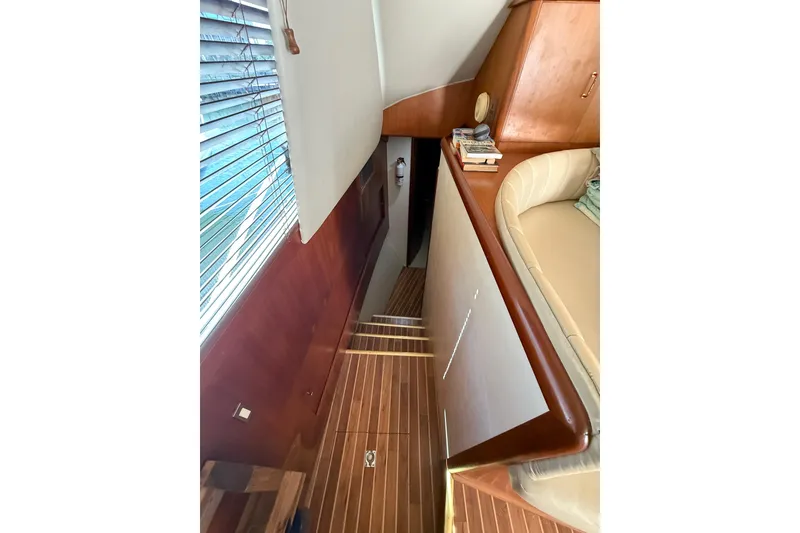 Slide: The Image of Interior of 1997 Ocean Yachts 40 Super Sport with wooden stairs and cozy seating area. - 12