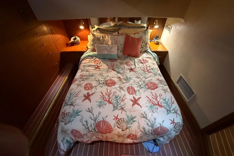 Slide: The Image of Cozy bedroom in 1997 Ocean Yachts 40 Super Sport with nautical-themed bedding. - 13
