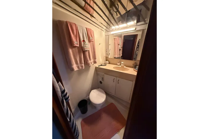 Slide: The Image of Bathroom interior of 1997 Ocean Yachts 40 Super Sport, featuring towels and vanity. - 17
