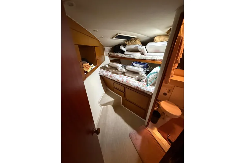 Slide: The Image of Interior cabin of 1997 Ocean Yachts 40 Super Sport with bunk beds and storage. - 19