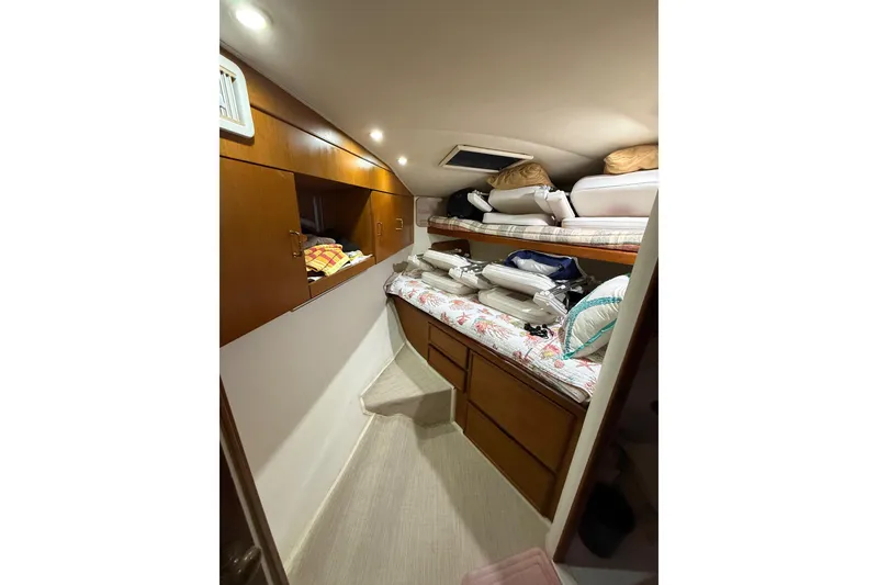 Slide: The Image of 1997 Ocean Yachts 40 Super Sport cabin interior with wooden cabinets and bunk beds. - 21