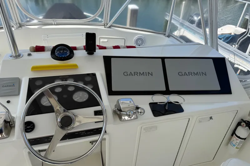 Slide: The Image of Cockpit of 1997 Ocean Yachts 40 Super Sport with Garmin navigation displays and steering wheel. - 22