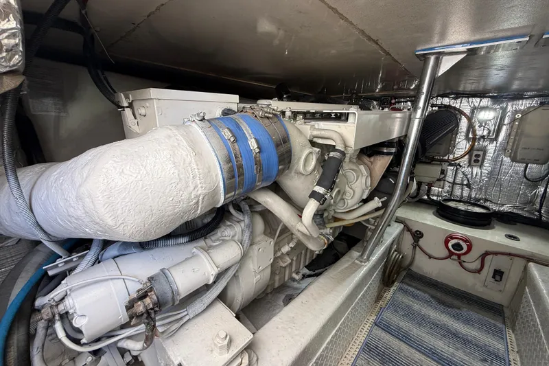 Slide: The Image of Engine room of a 1997 Ocean Yachts 40 Super Sport, showcasing detailed machinery and components. - 28