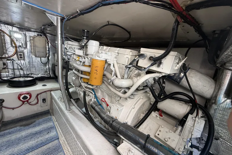 Slide: The Image of Engine room of a 1997 Ocean Yachts 40 Super Sport, showcasing detailed machinery and wiring. - 29