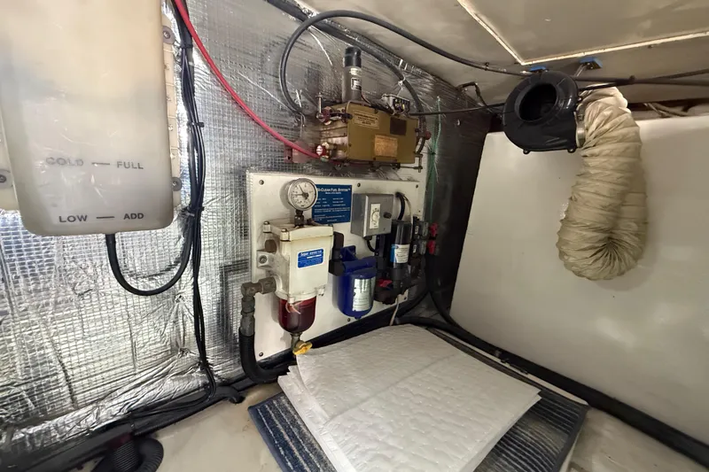 Slide: The Image of Engine room of 1997 Ocean Yachts 40 Super Sport with fuel system and insulation. - 30