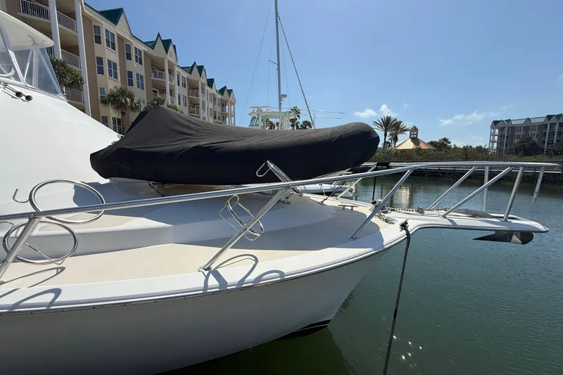 Slide: The Image of 1997 Ocean Yachts 40 Super Sport docked near waterfront buildings under clear sky. - 5