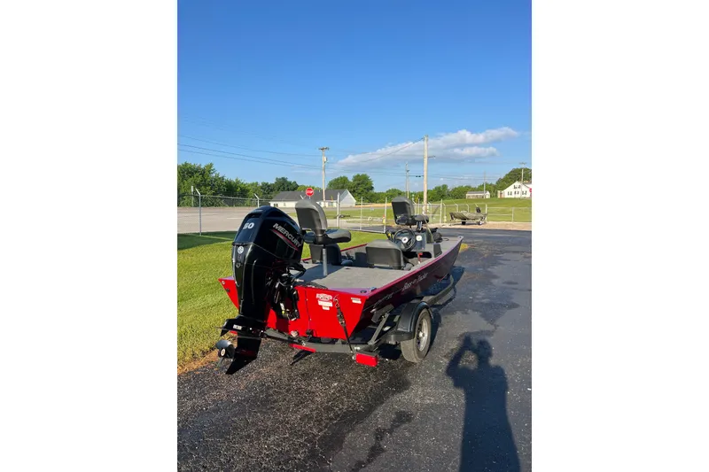 Slide: The Image of 2026 Tracker Bass Tracker Classic XL boat with Mercury engine on a sunny day. - 4