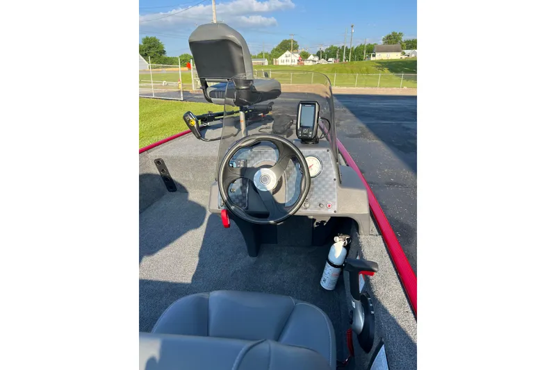 Slide: The Image of 2026 Tracker Bass Tracker Classic XL boat dashboard with steering wheel and navigation equipment. - 5