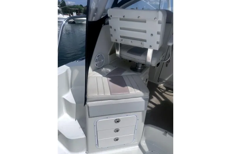 Slide: The Image of 2007 Sailfish 2660 WAC boat interior with cushioned seating and storage compartments. - 12