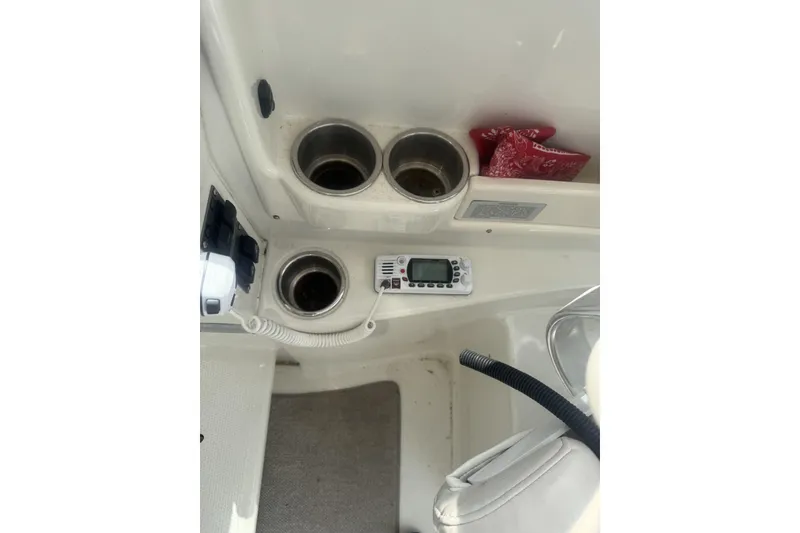 Slide: The Image of 2007 Sailfish 2660 WAC boat interior with cup holders and radio equipment. - 14