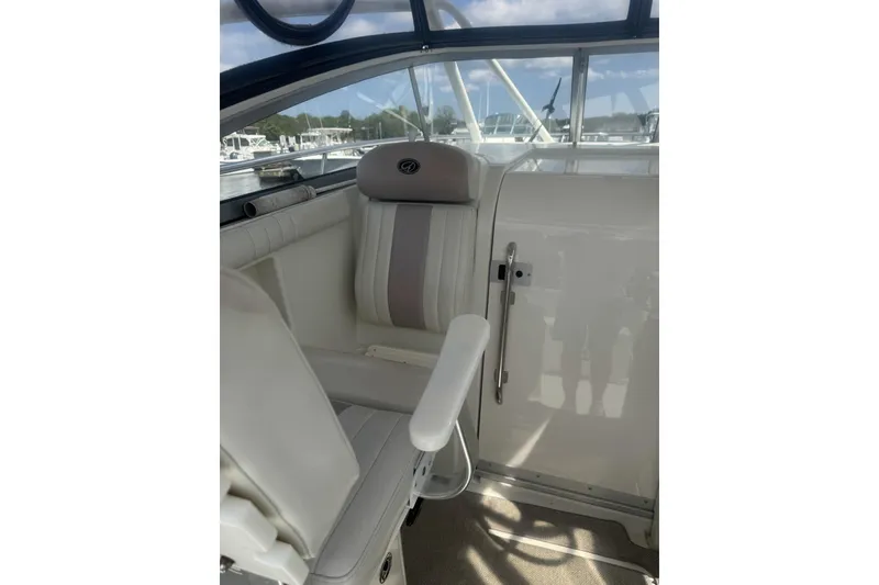 Slide: The Image of Interior of 2007 Sailfish 2660 WAC boat, featuring white seating and helm area. - 15