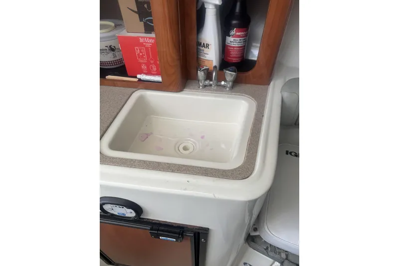 Slide: The Image of 2007 Sailfish 2660 WAC boat sink with cleaning supplies and storage cabinet. - 16