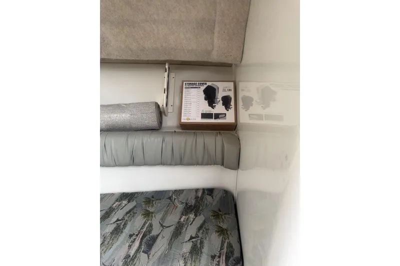 Slide: The Image of Interior of 2007 Sailfish 2660 WAC boat with storage cover and rolled mat. - 20