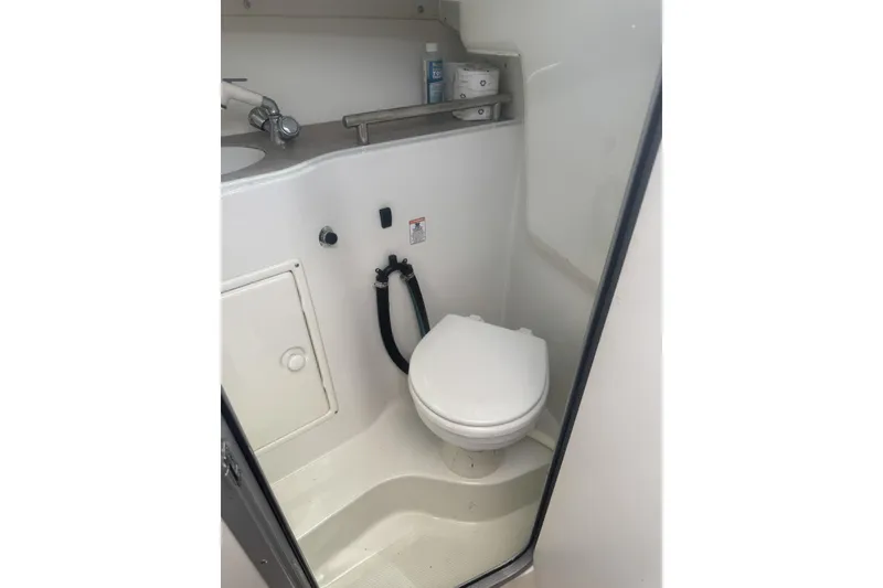 Slide: The Image of 2007 Sailfish 2660 WAC boat bathroom with toilet and sink. - 21